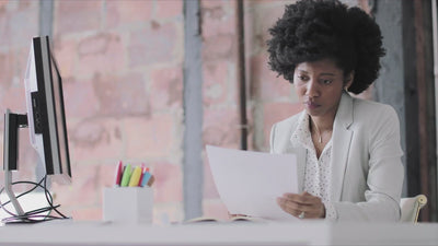 reachXOD - Facing Unrealistic Expectations - Business woman working on documents